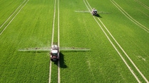 Aerial view of two sprayers in crop field Aerial view of two sprayers in crop field