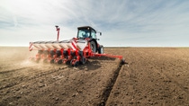 Farmer seeding crops at field