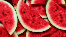 A large number of cut slices of ripe watermelon.Texture or background A large number of cut slices of ripe watermelon.Texture or background