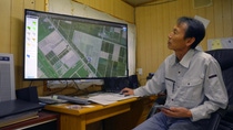 A farmer looking at a Digital Farming map