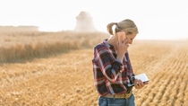 Modern female farmer with tablet on her wheat field Modern female farmer with tablet on her wheat field