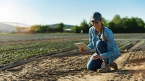 Farmer in the field with soil in hand
