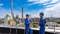 Two production workers have a conversation with each other Two production workers have a conversation with each other