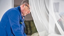 BASF employee performing quality control on mosquito nets BASF employee performing quality control on mosquito nets