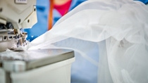 Close up picture of a mosquito net being sewed Close up picture of a mosquito net being sewed