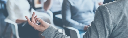 Business coach. Rear view of man gesturing with hand while standing against defocused group of people sitting at the chairs in front of him ; Shutterstock ID 439214011; Jobnummer: 02200; Projekt: PrÃ¤sentation; Endkunde: BASF SE, G-EVO/EB, Frau Sauer; Sonstiges: BASF SE, ESI/K Matthias Baque