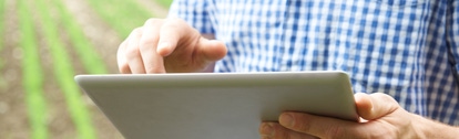 Close Up Of Farmer Using Digital Tablet On Organic Farm