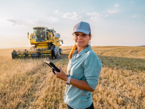 Female Farmer is Holding a Digital Tablet in a Farm Field. Smart Farming Female Farmer is Holding a Digital Tablet in a Farm Field. Smart Farming