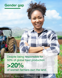 Woman in a field in front of a tractor