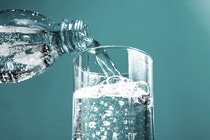 Stream of clean water flowing in a glass. Pouring water into glass.